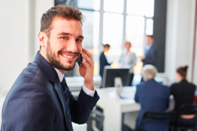 man smiling while calling from his phone